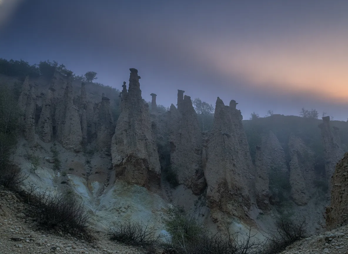 Wooden pathway winding through the earth pyramids of Đavolja Varoš at sunset, casting long shadows