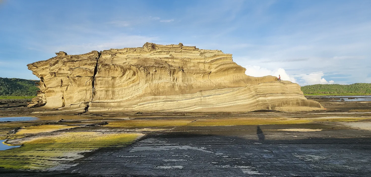 Dramatic view of Magasang Rock Formation with waves crashing against its base at Biri Rock Formations, Northern Samar, Philippines