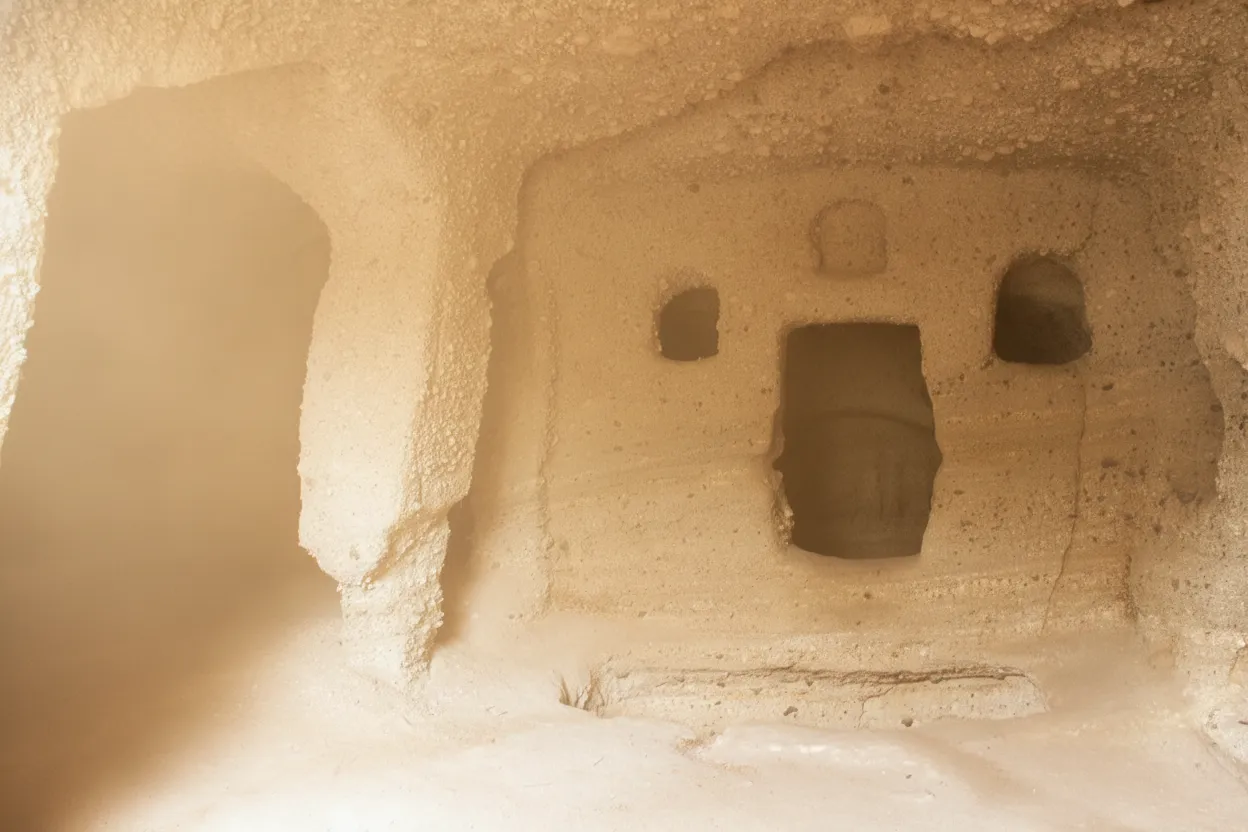 Entrance to the Catacombs of Milos, a simple doorway leading into the ancient underground burial site beneath the Greek island's landscape.