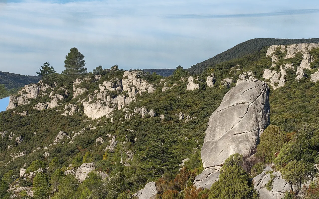 Detailed view of a uniquely shaped dolomite rock formation, resembling a human figure, against the backdrop of the Cirque de Mourèze landscape.
