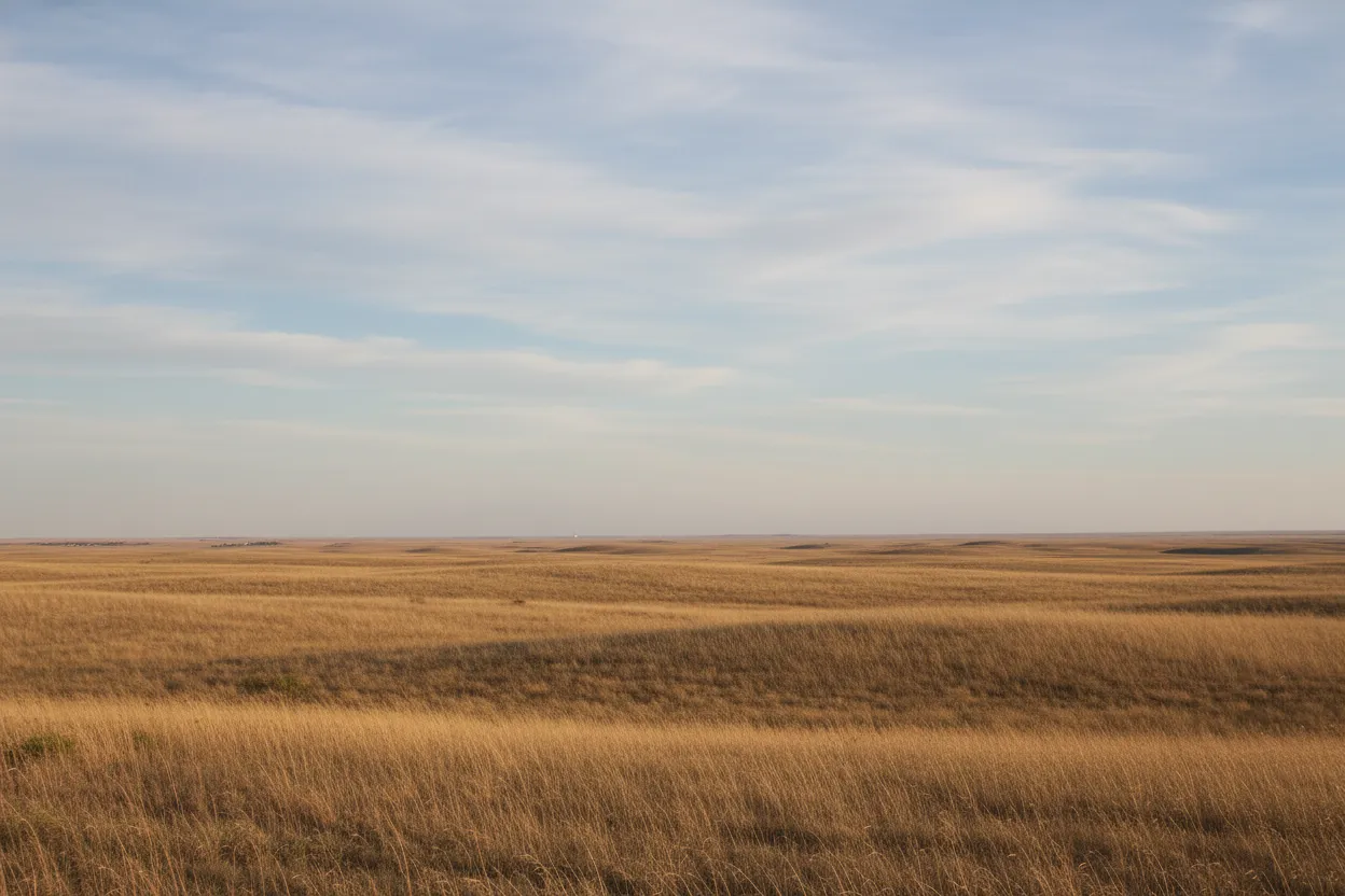 A modern view of a vast, empty prairie landscape in South Dakota, symbolizing the former site of Fossil Cycad National Monument.