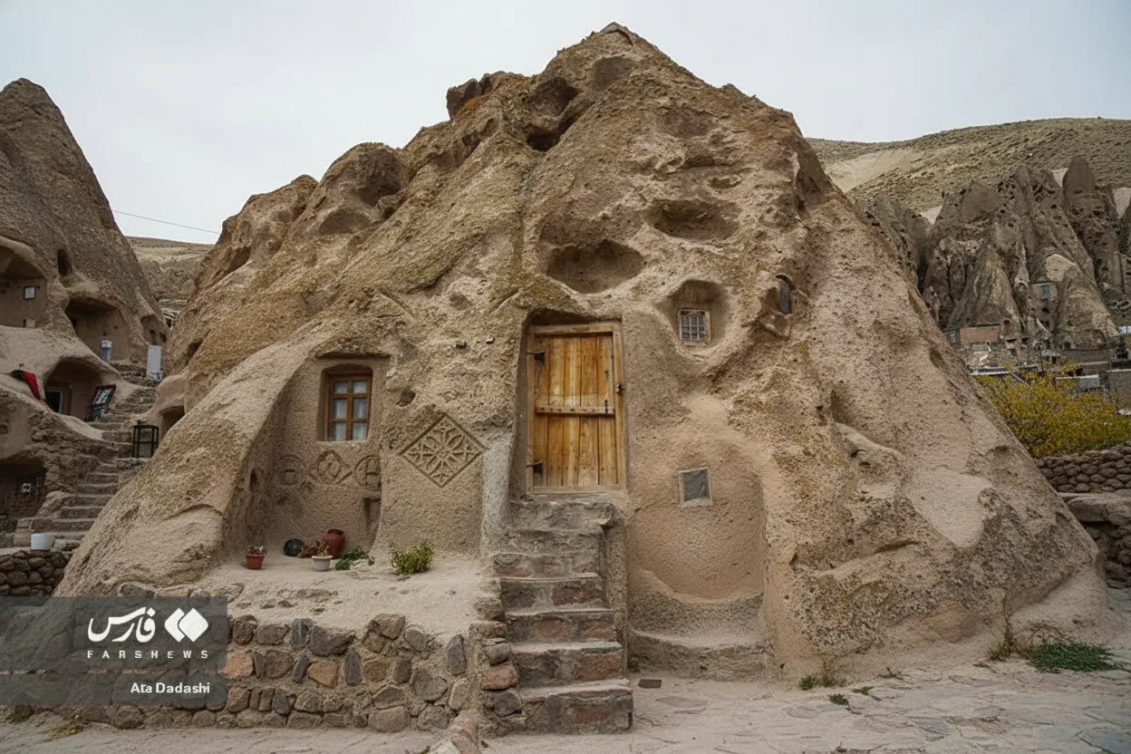 Close-up of a carved cave home in Kandovan, showing a door, window, and intricate details of the volcanic rock.