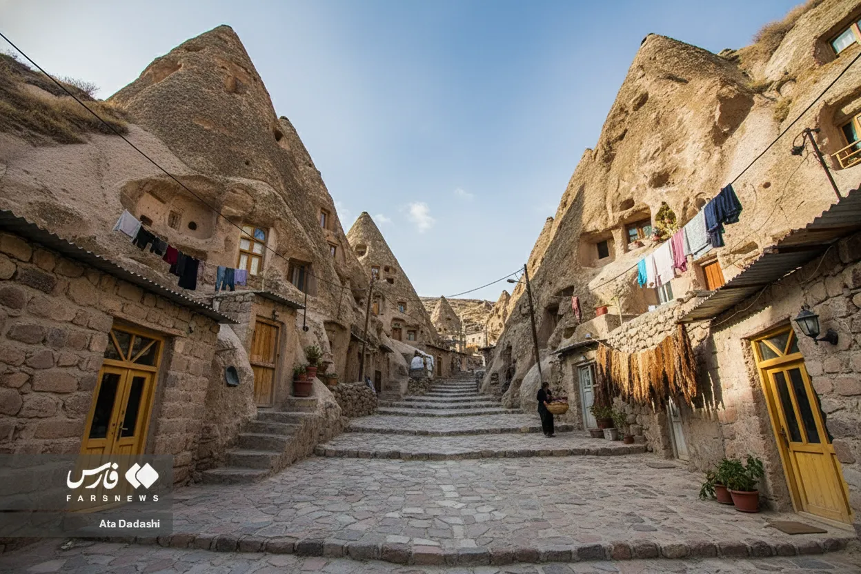 A local woman in traditional attire walking through the narrow pathways of Kandovan village, showcasing daily life.