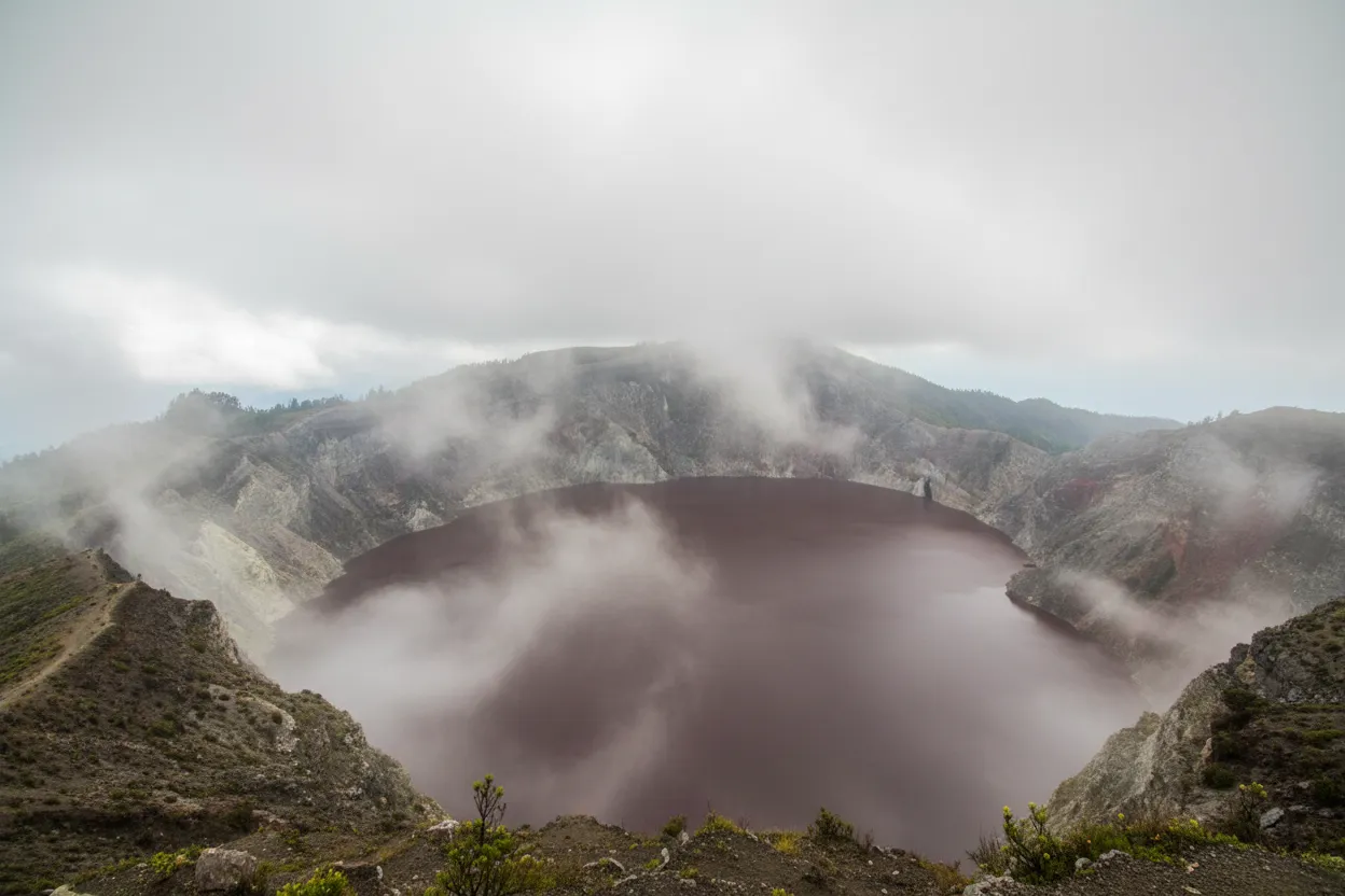 A panoramic view of the three Kelimutu lakes from a higher vantage point, showcasing their distinct and vibrant colors.
