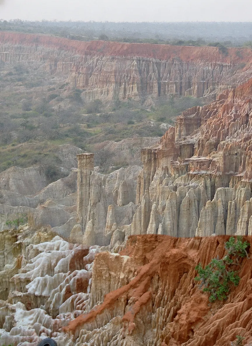 Panoramic view of Miradouro da Lua's eroded red cliffs descending towards the Atlantic Ocean in Angola.