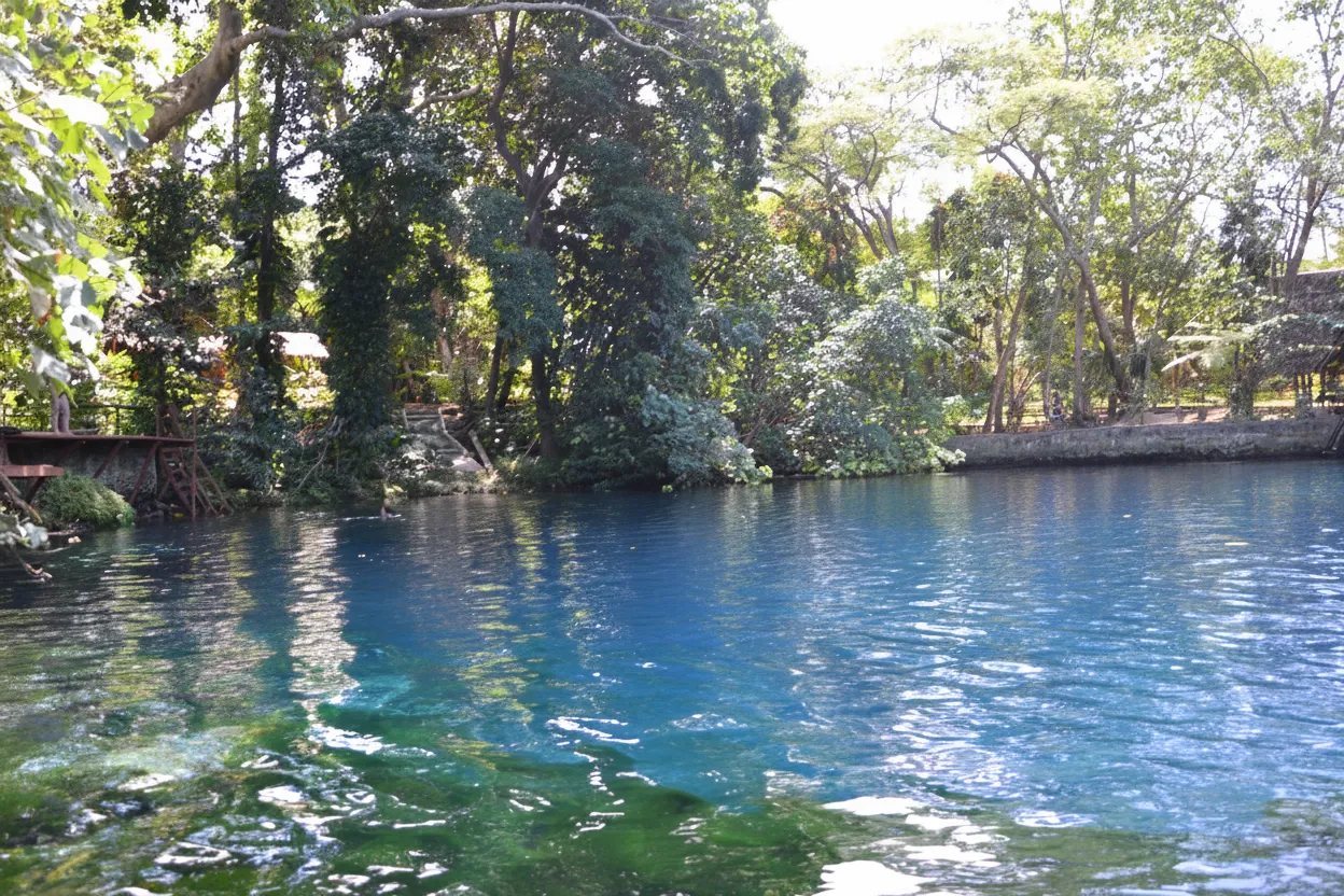 Imagine stumbling upon an otherworldly oasis, where the jungle canopy parts to reveal a pool of water so intensely sapphire it seems poured from the sky.
