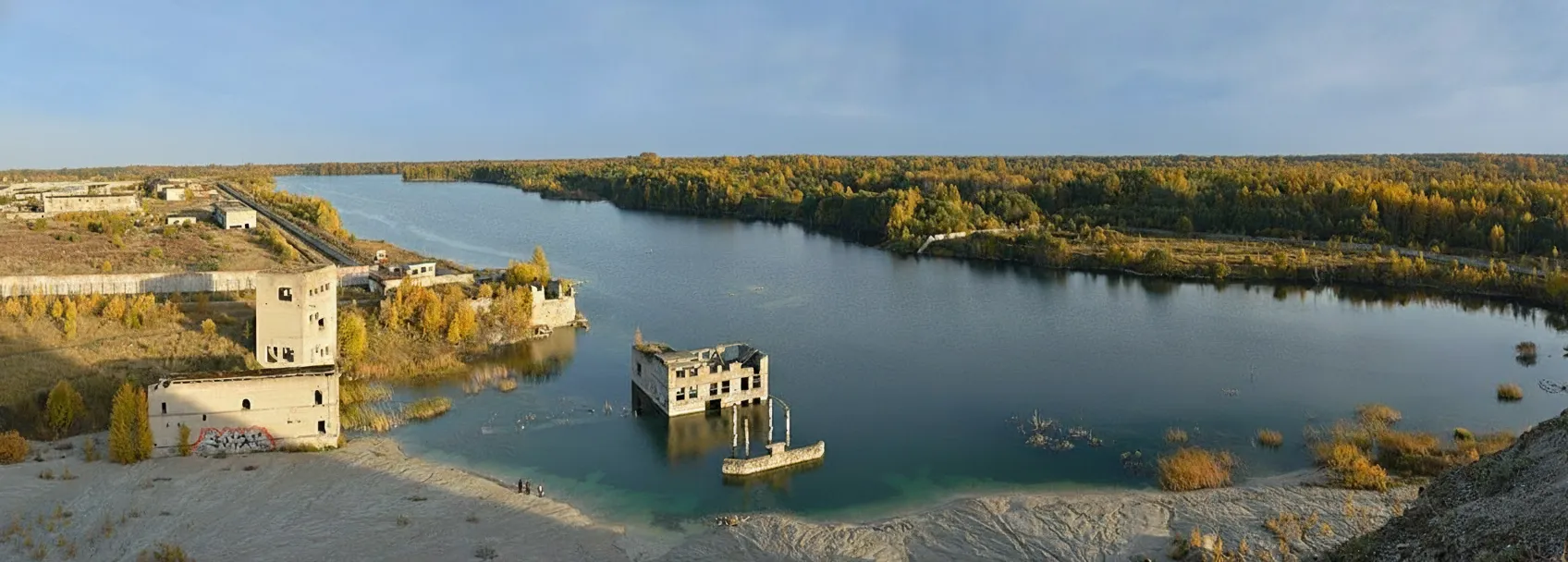Aerial view of Rummu Underwater Prison with turquoise water and partially submerged structures