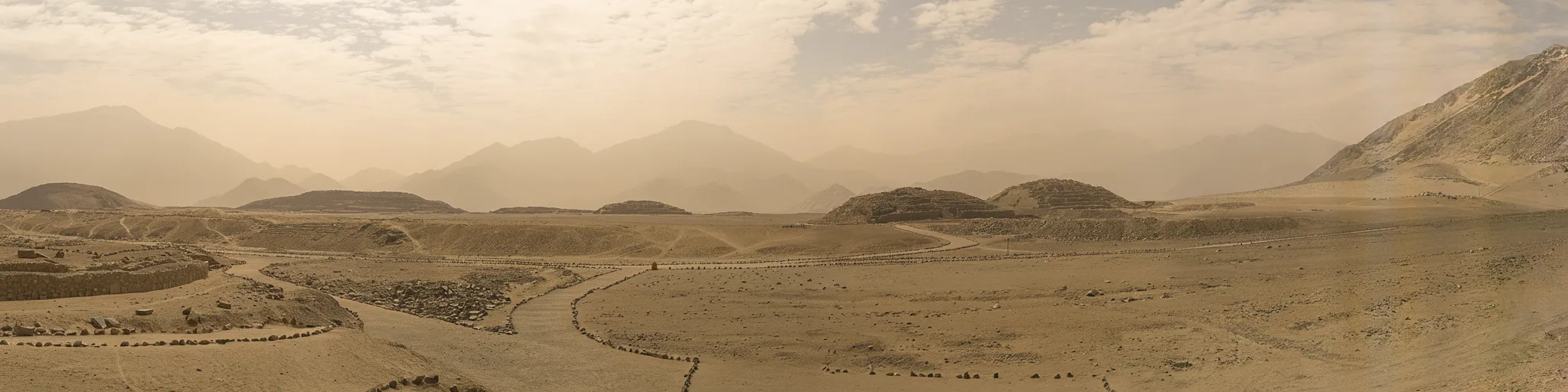 Close-up of a circular sunken court at Caral-Supe, with stepped stone walls and a clear central area.