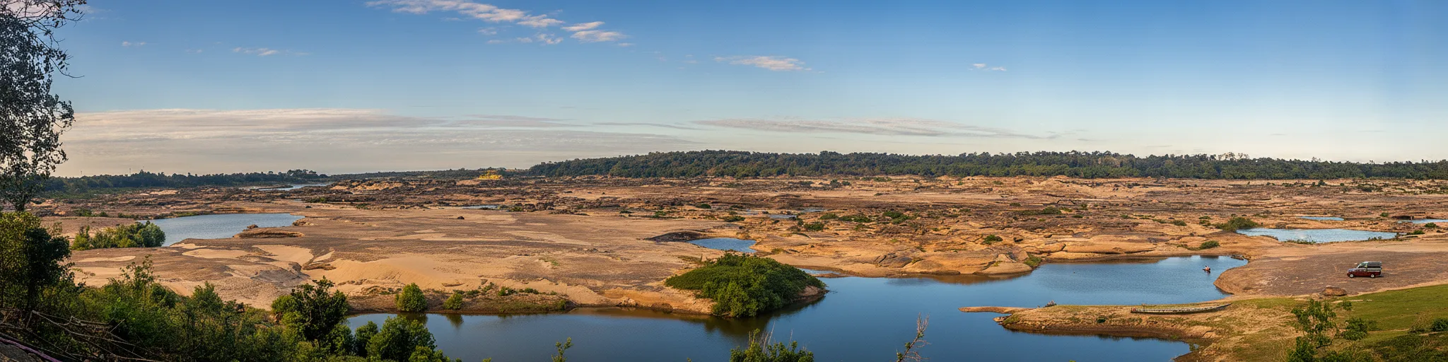 Imagine a landscape where an ancient river unveils a Martian topography, carving thousands of bizarre whirlpool-sculpted potholes into sandstone during its seasonal retreat.