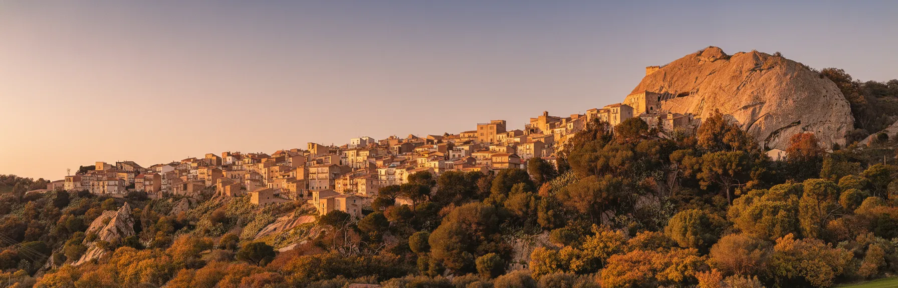This Sicilian village isn't just *near* the rock; many of its homes, and even its ancient castle, are literally carved *into* the sandstone cliffs.
