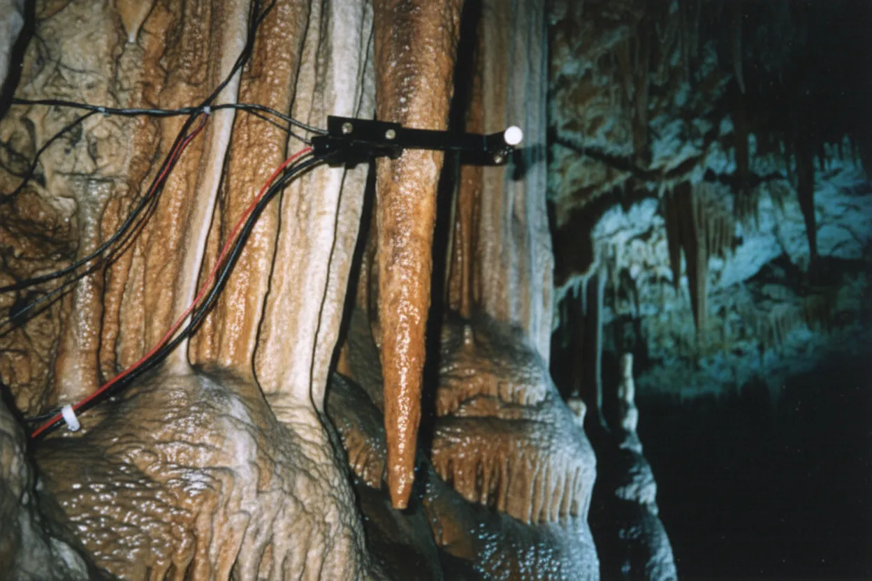 A close-up of a stalactite being struck by a rubber mallet, part of the Great Stalacpipe Organ