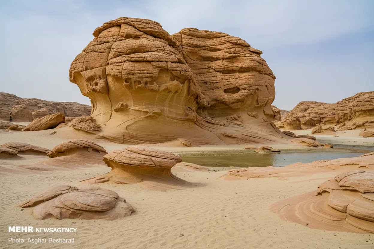 A person standing amidst the towering eroded rock formations of the Valley of the Stars, providing a sense of scale against the dramatic geological features.