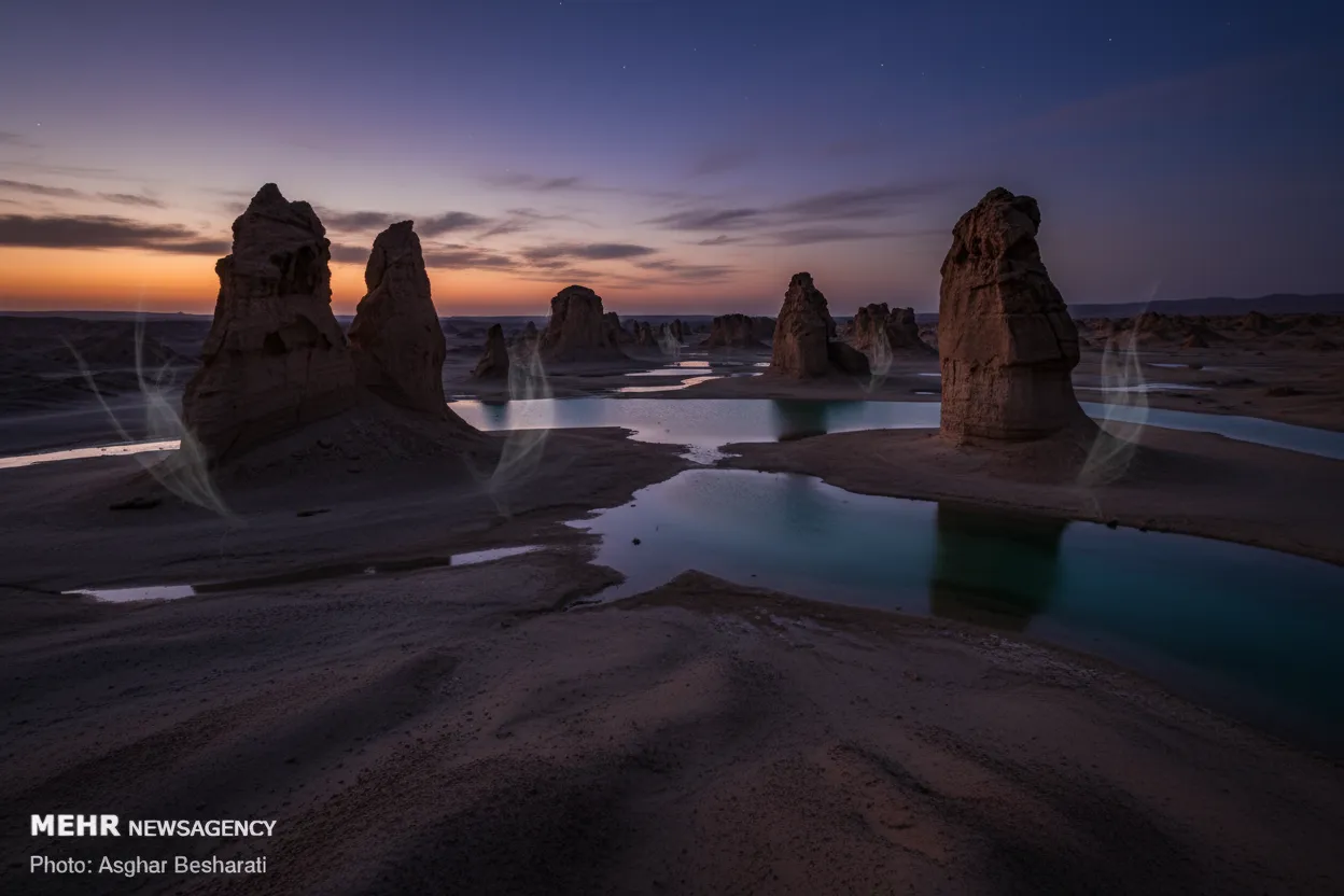 The Valley of the Stars at sunset, with long shadows stretching across the dramatic rock formations, showcasing the magical light and mystical atmosphere.