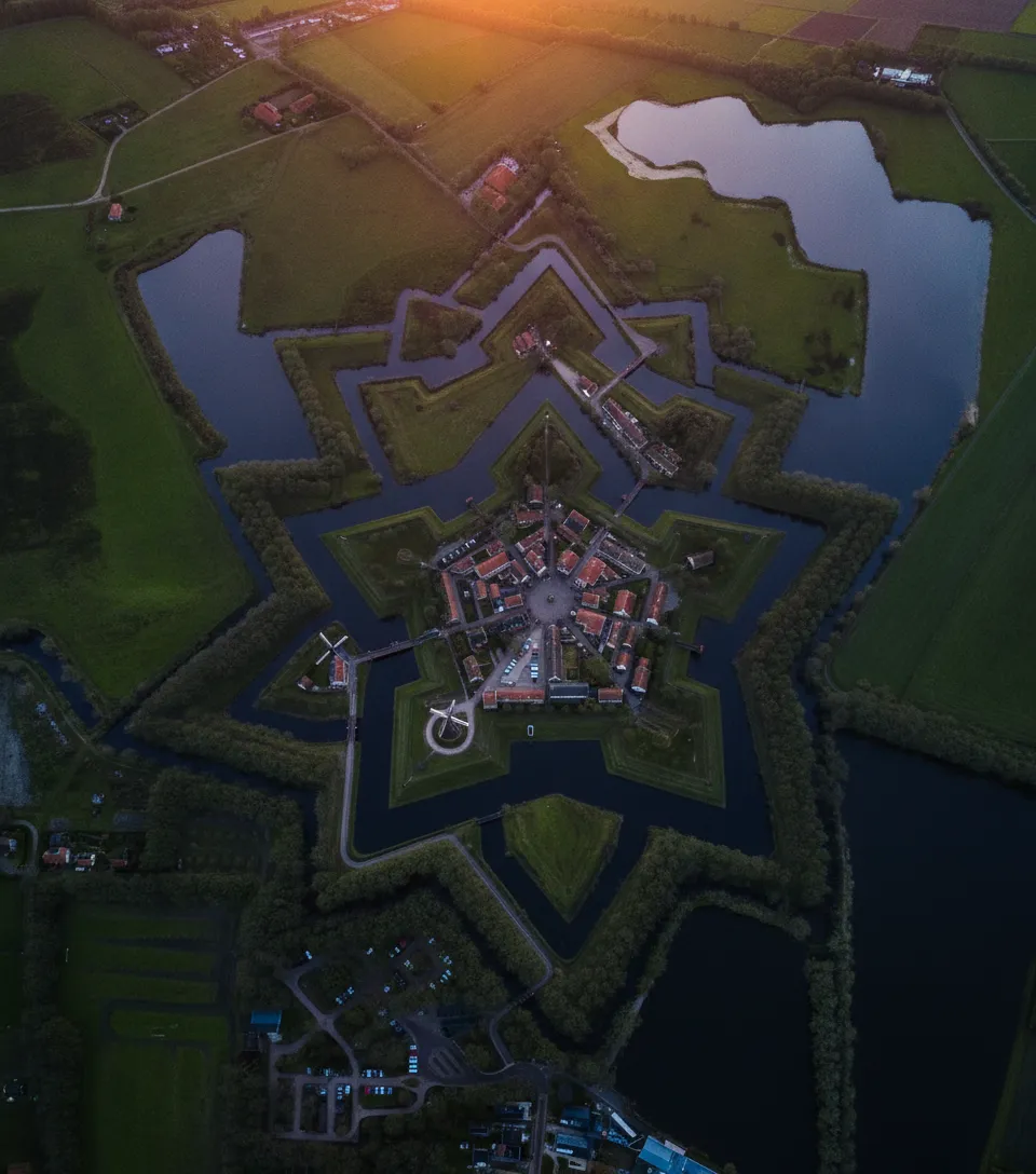Step inside Vesting Bourtange, a perfectly preserved 16th-century star-shaped fortress village in the Netherlands, looking as if time stood still.
