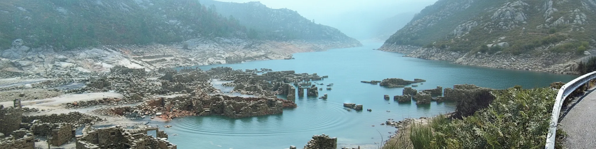 Eerie stone ruins of Vilarinho das Furnas emerging from the reservoir waters during a drought